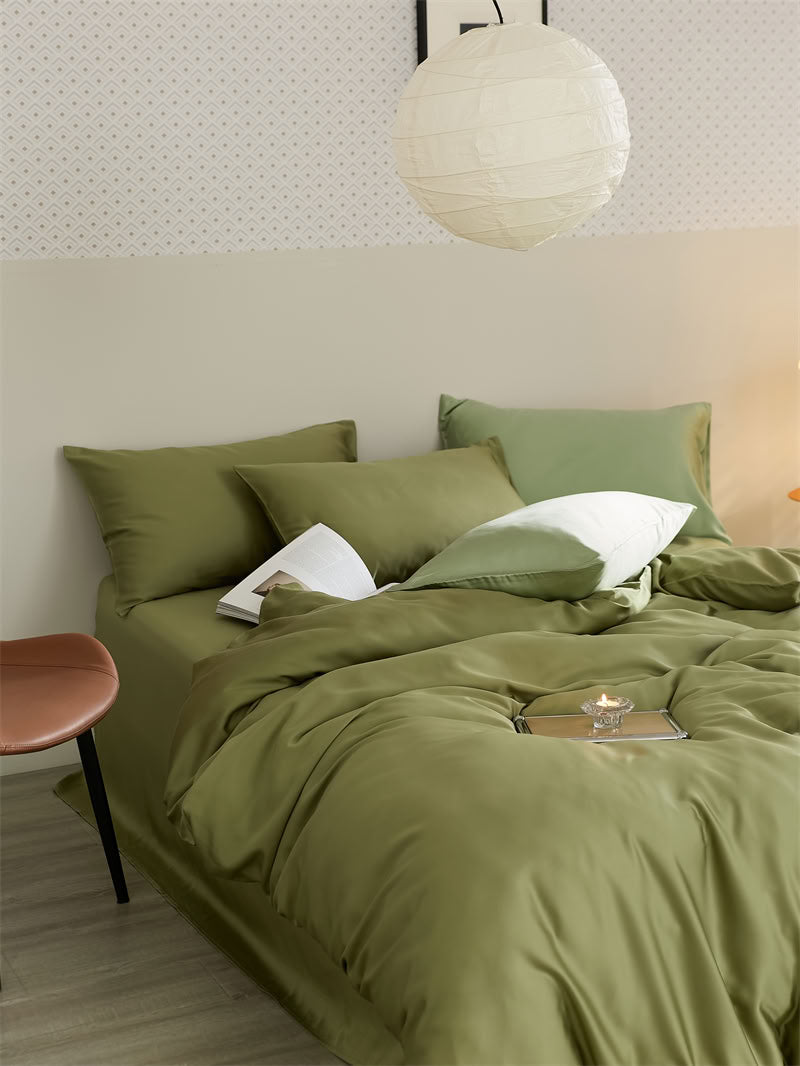 Olive green Tencel bedding set styled in a minimalist bedroom with paper lantern and warm lighting - RoomDen