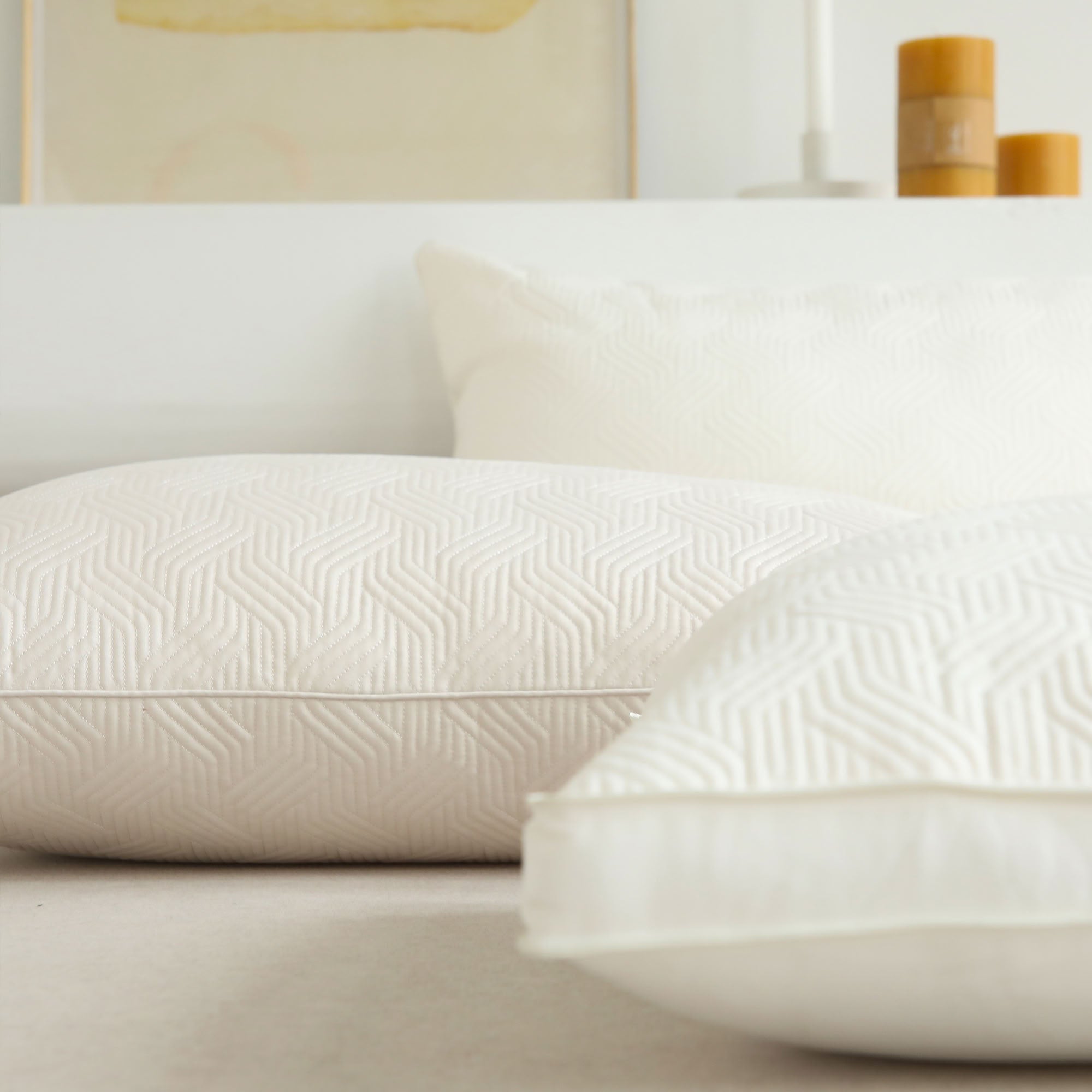 Minimalist beige plant-based pillow inserts layered on neutral bedding - RoomDen