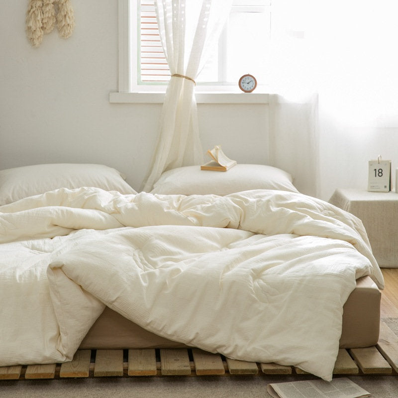 Warm beige-toned bedroom with sustainable duvet insert and wooden ladder decor - RoomDen