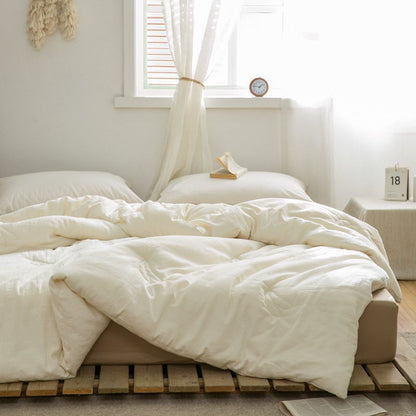 Warm beige-toned bedroom with sustainable duvet insert and wooden ladder decor - RoomDen