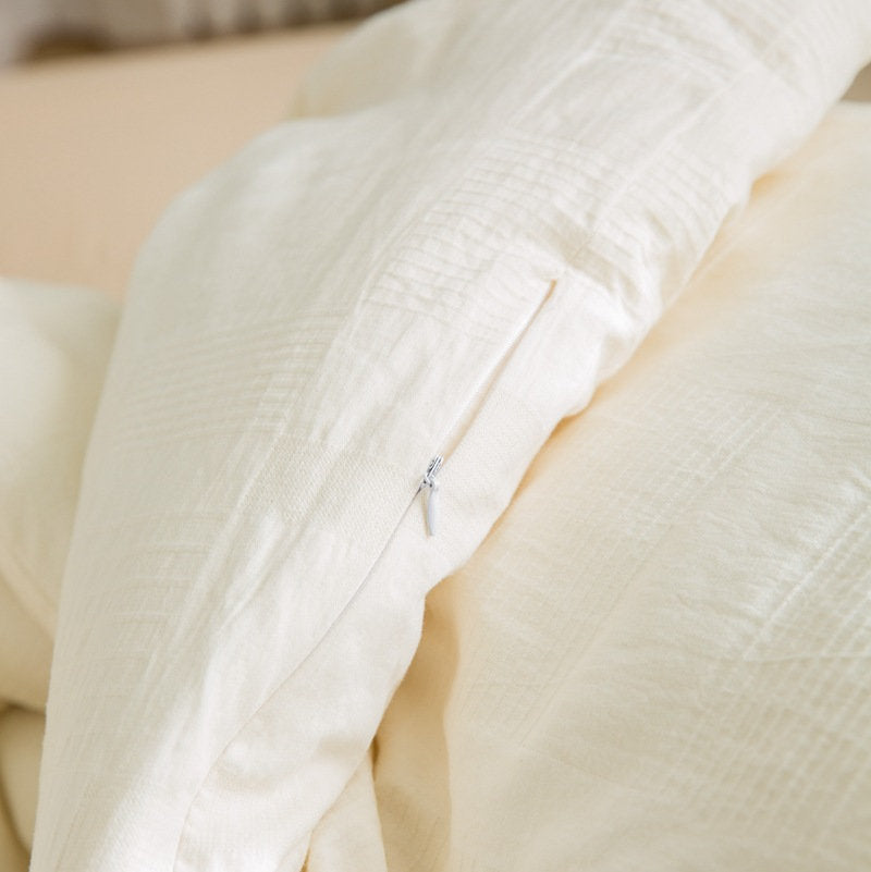 Close-up of cotton fabric zipper detail on duvet insert corner - RoomDen
