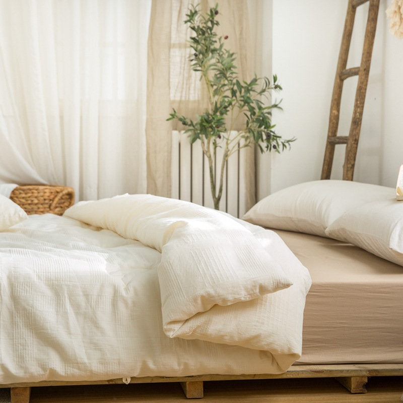 Cozy minimalist bedroom featuring eco-friendly duvet insert with neutral palette - RoomDen