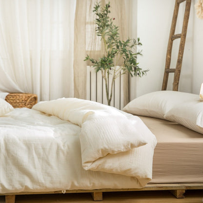 Cozy minimalist bedroom featuring eco-friendly duvet insert with neutral palette - RoomDen