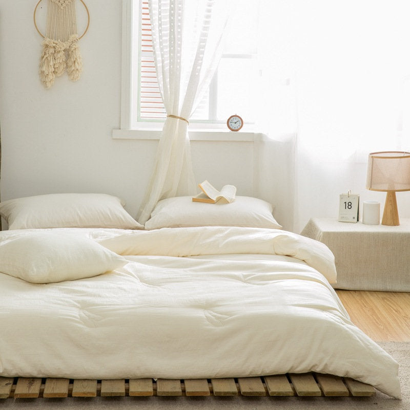 Cream duvet insert styled on bed with soft natural light and linen curtains - RoomDen