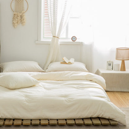 Cream duvet insert styled on bed with soft natural light and linen curtains - RoomDen