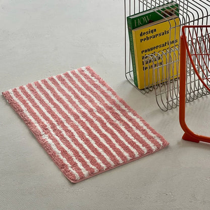 Pink and white wavy striped shaggy rug placed next to magazine rack - RoomDen