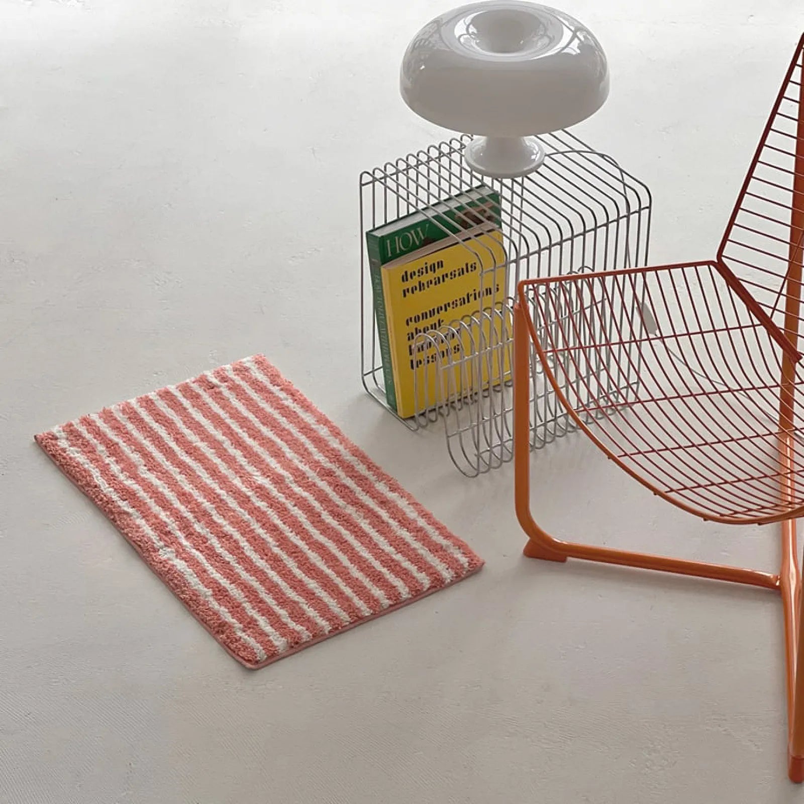 High angle view of pink irregular stripe accent rug in a minimalist room - RoomDen