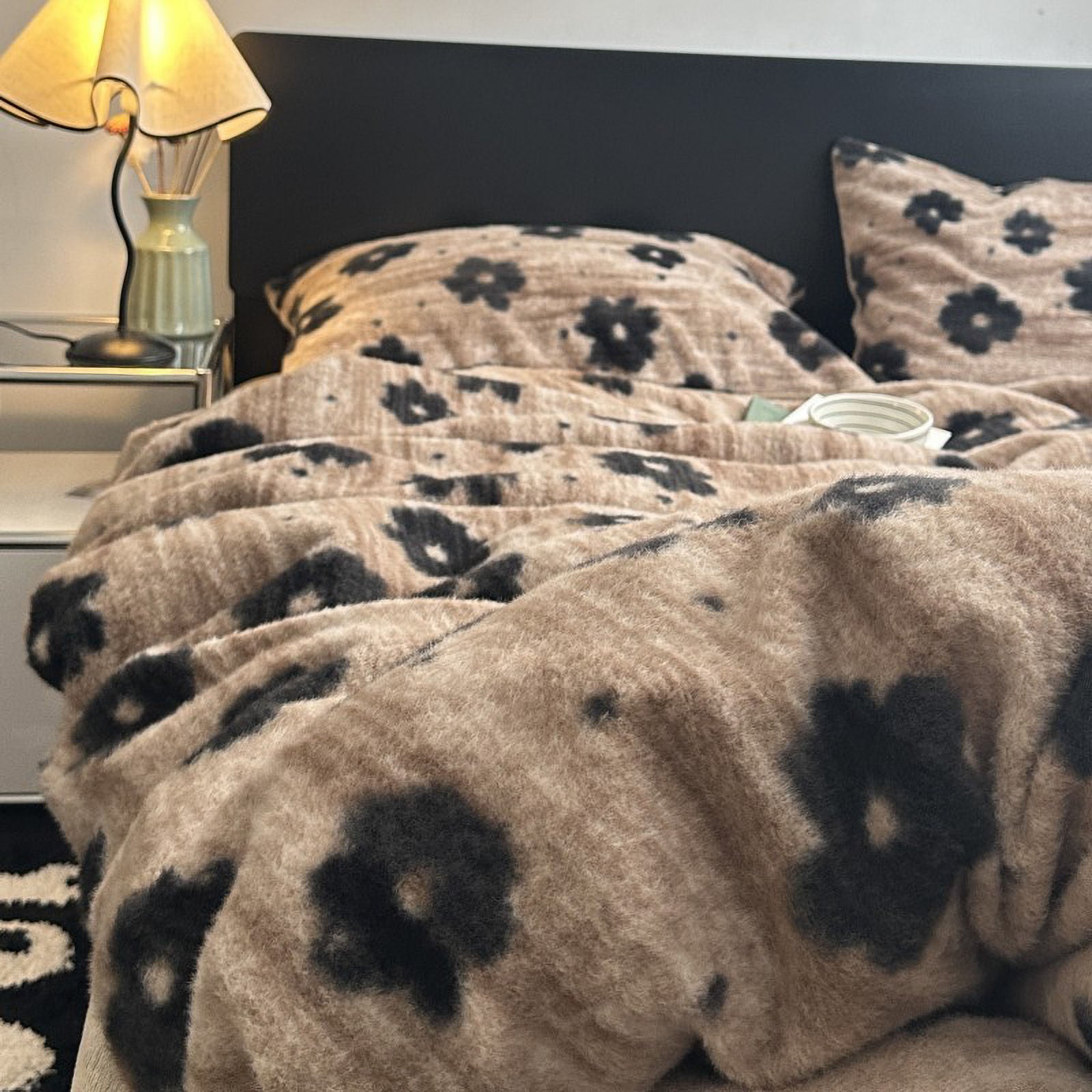 Side view of beige and black flower bedding set, soft warm lighting atmosphere.