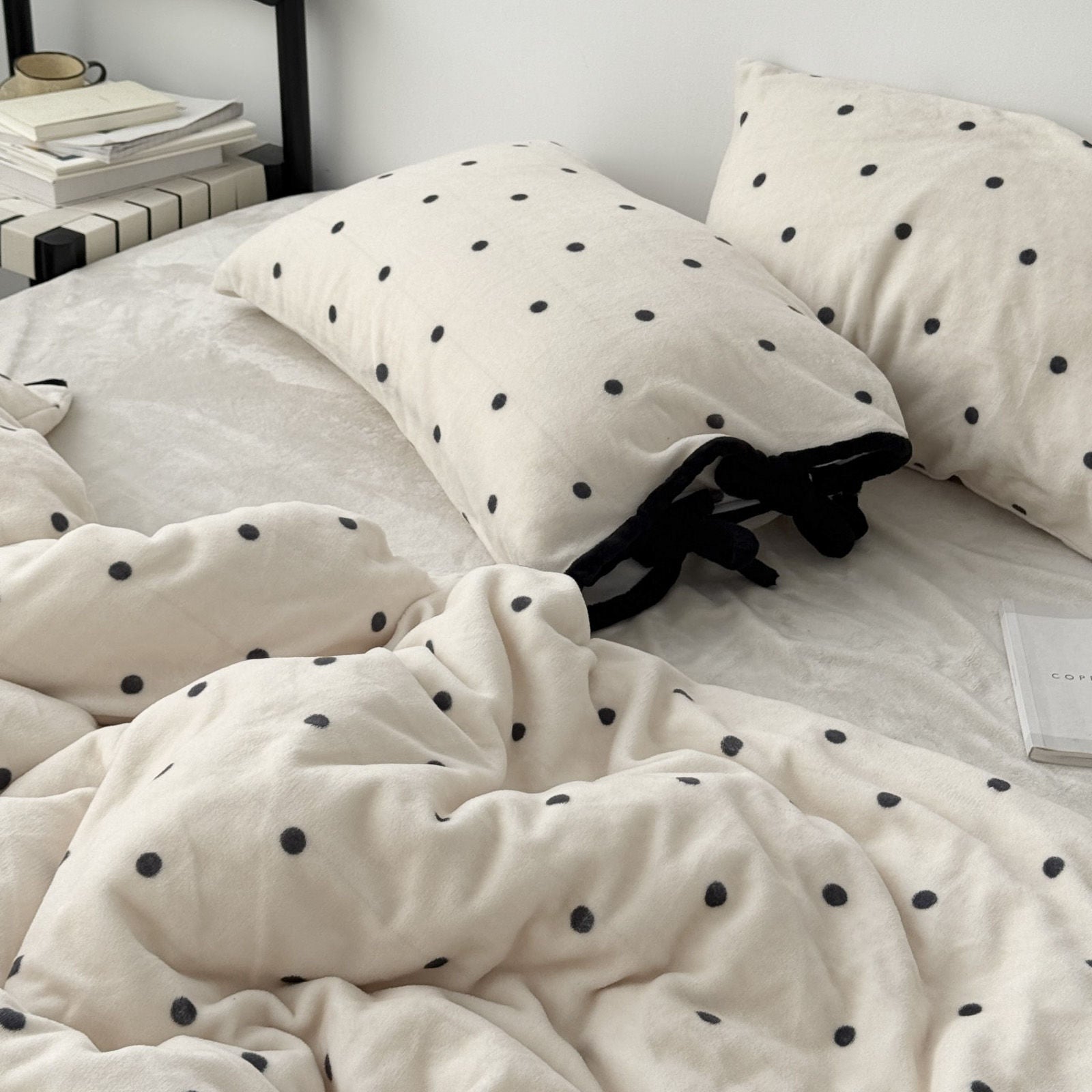 Plush pillowcase with black bow ties and polka dot pattern detail RoomDen