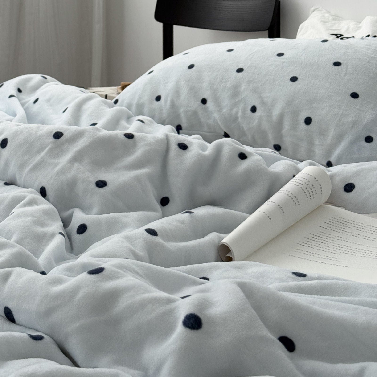 Cozy bedroom setup featuring cream and black polka dot bedding set RoomDen