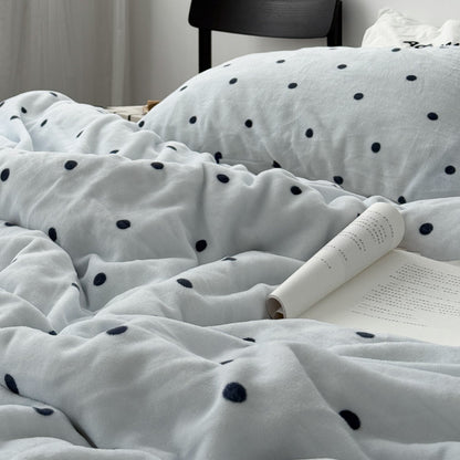Cozy bedroom setup featuring cream and black polka dot bedding set RoomDen