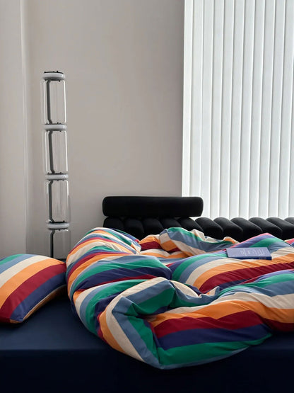 Colorful striped cotton bedding and pillow arrangement in minimalist room - RoomDen
