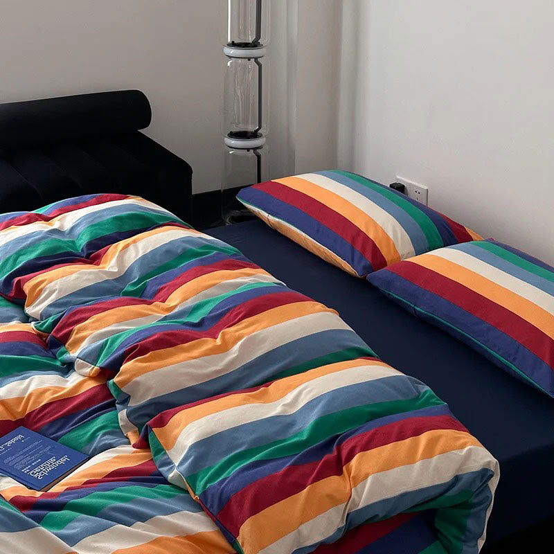 Modern bedroom with rainbow stripe bedding and bold color design - RoomDen