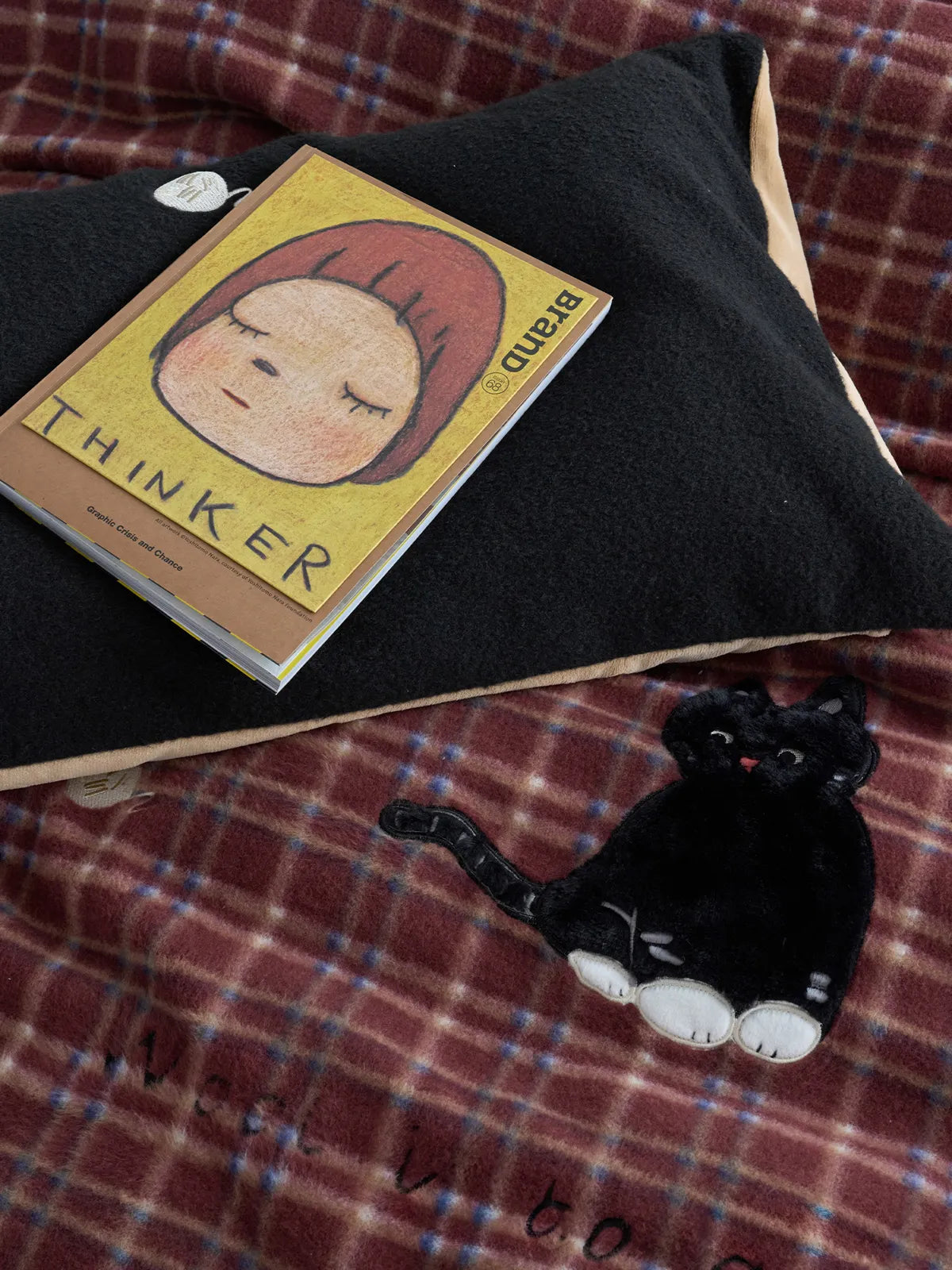 Detail shot of black cat embroidery on red plaid fleece duvet cover RoomDen.