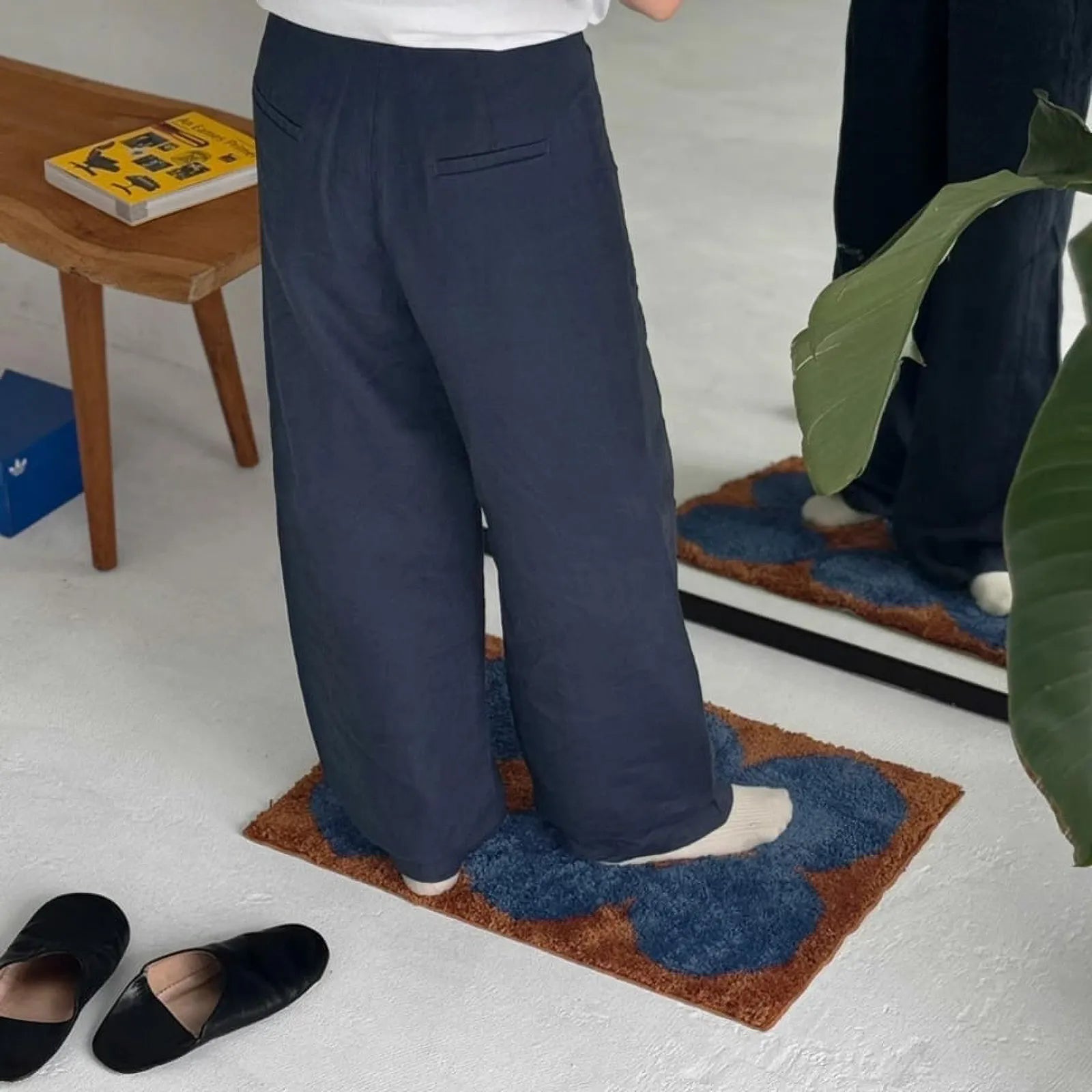 Person standing on the retro rug in front of a full-length mirror - RoomDen