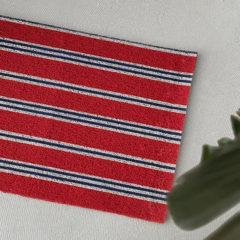 Close-up texture view of red PVC loops with blue and white stripe detail - RoomDen