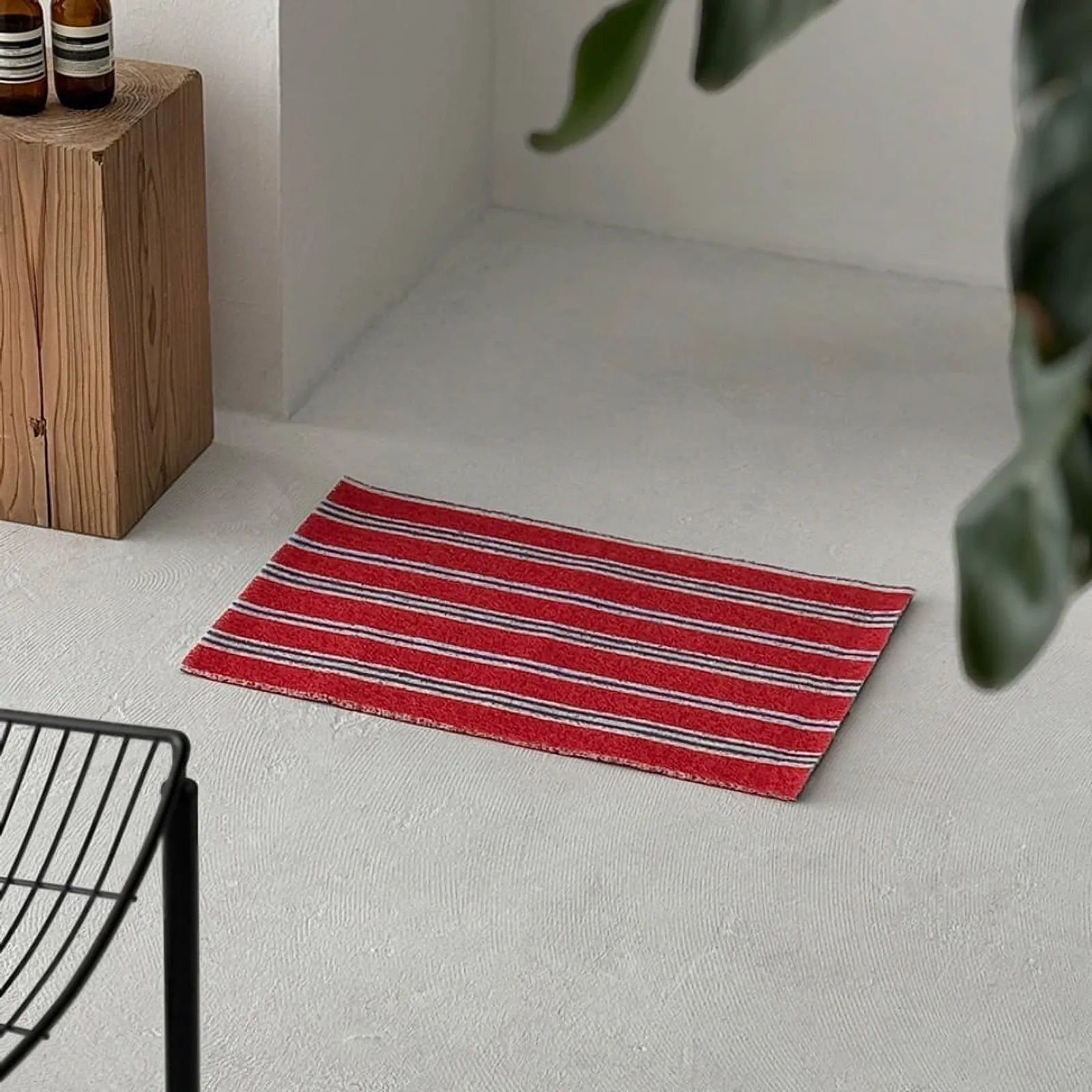 Full view of the Americana Red striped PVC mat in a minimalist setting.