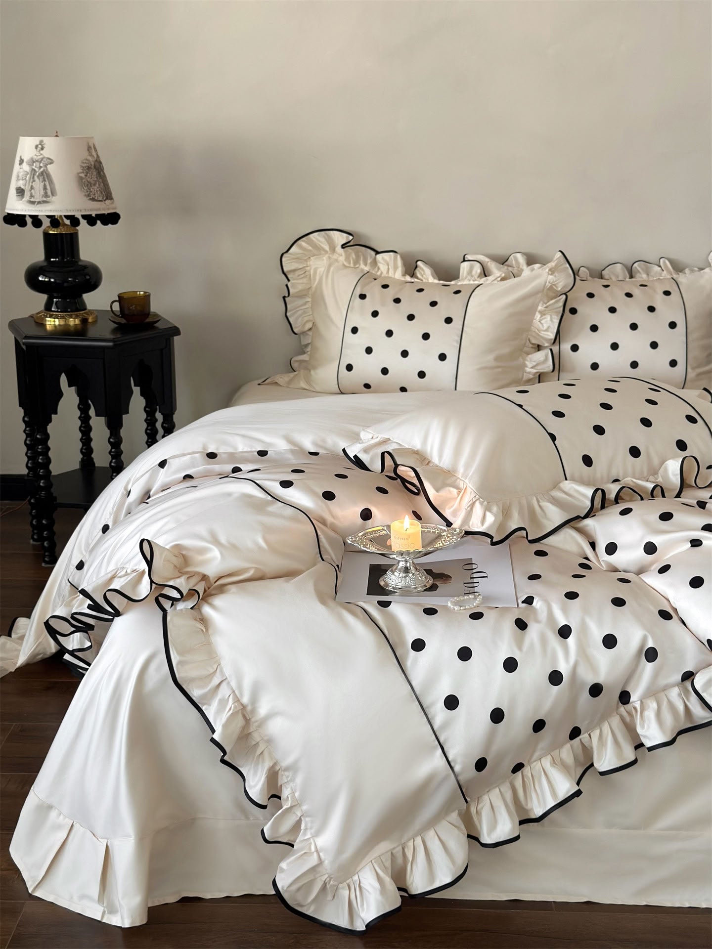 Close-up of silky beige tencel duvet cover with black dots and soft ruffle trim – RoomDen
