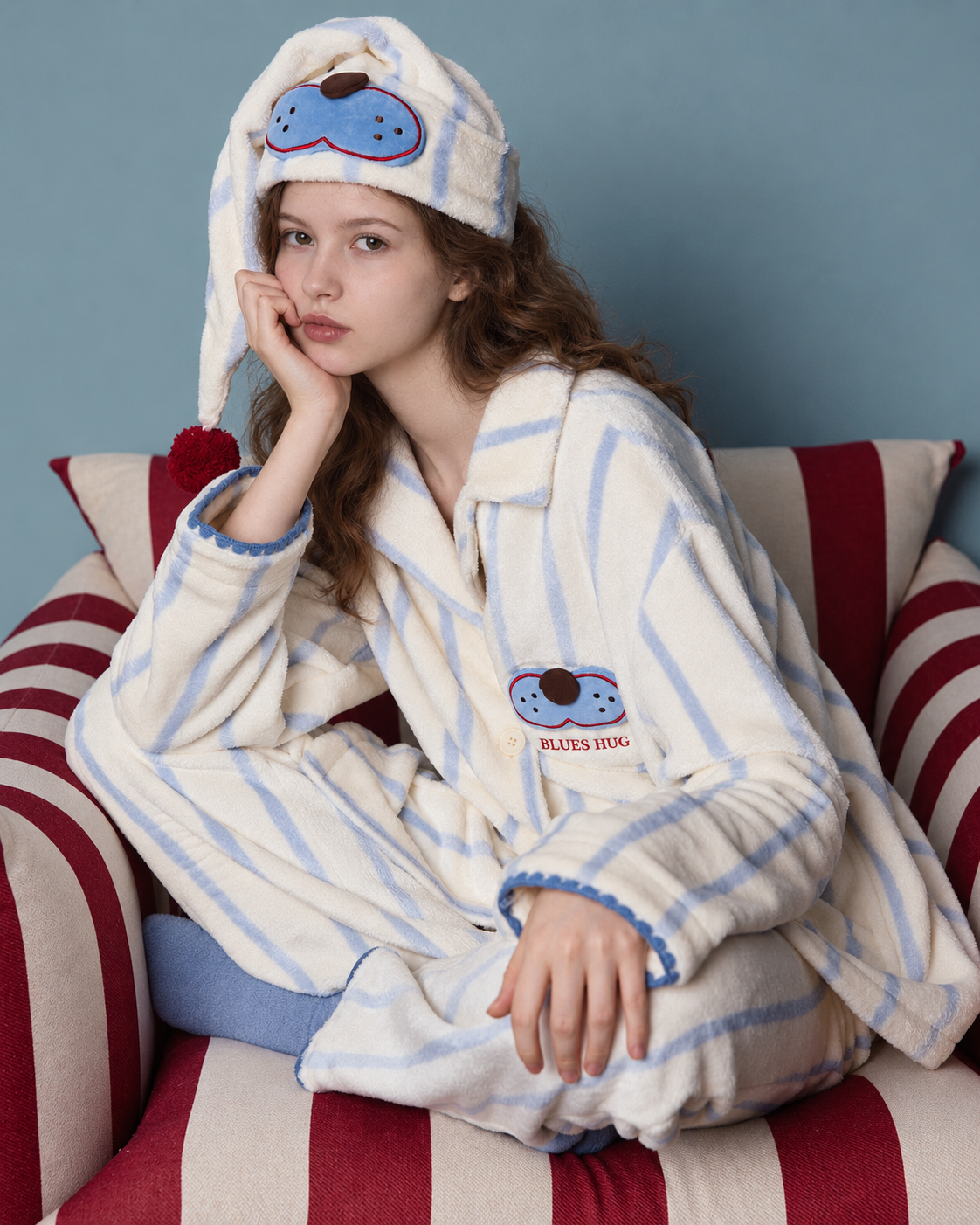 Striped Fleece Pajama Set – front seated view on a red-and-cream sofa - Roomden