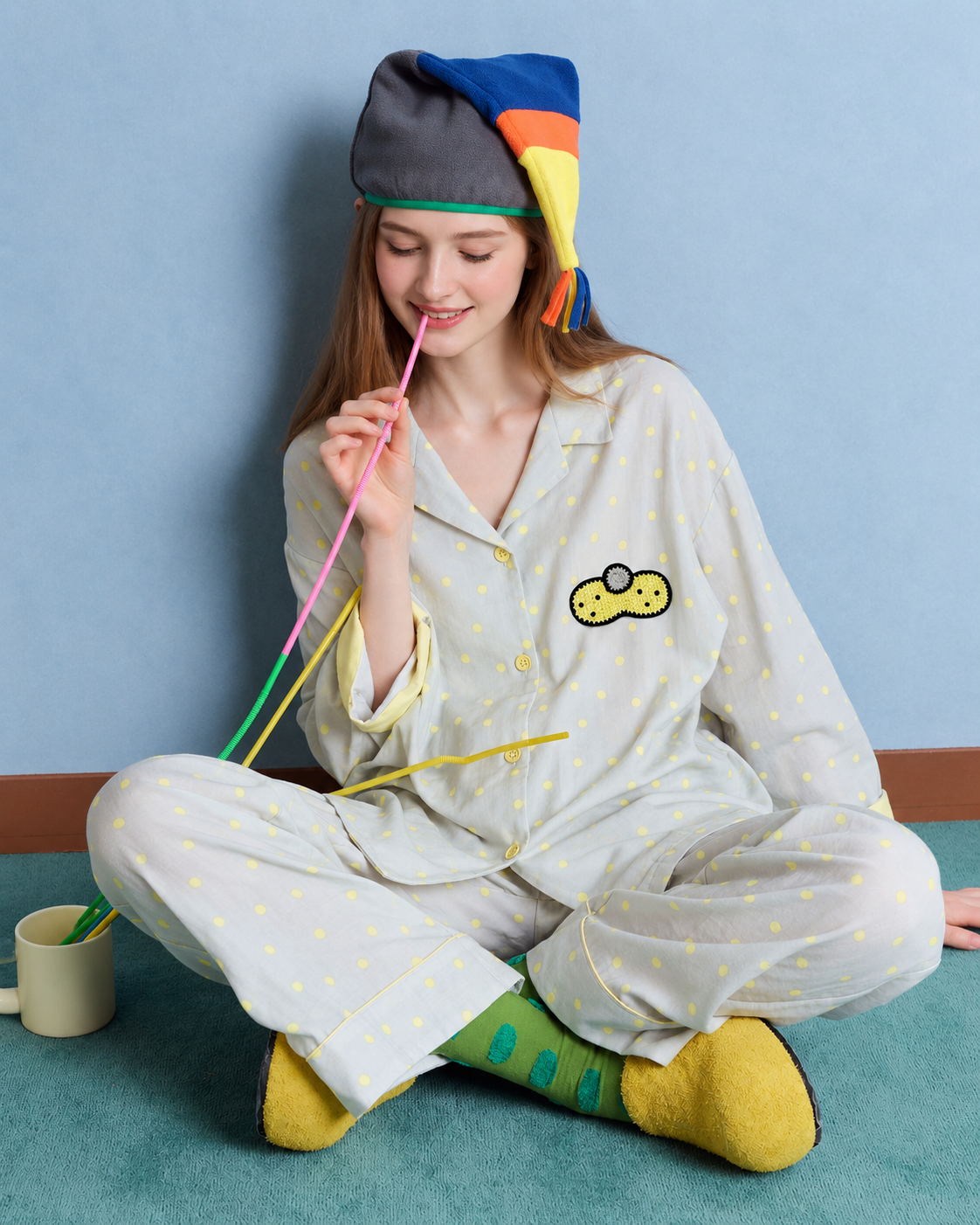 Women's gray and yellow dot cotton gauze pajama set – cross-legged seated view holding a straw - Roomden