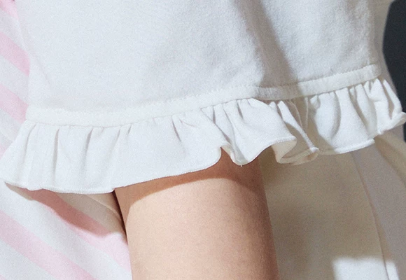 Close-up of the gathered white ruffled sleeve edge