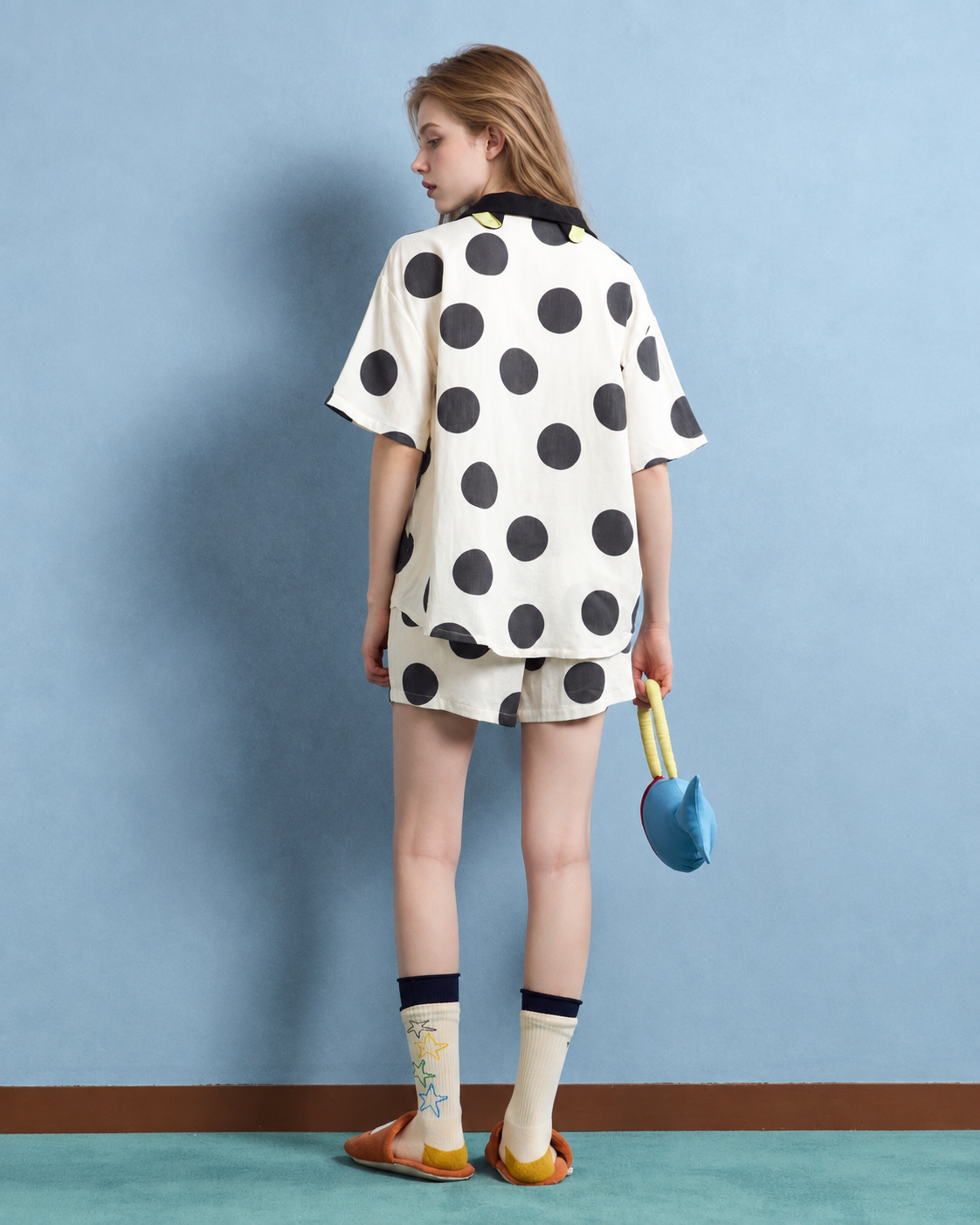 Back view of cream polka dot pajama set showing yellow collar ears.