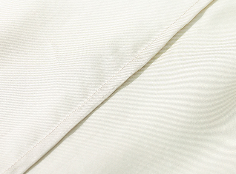 Apricot-cream Inkshore robe with blue botanical trim — fabric close-up