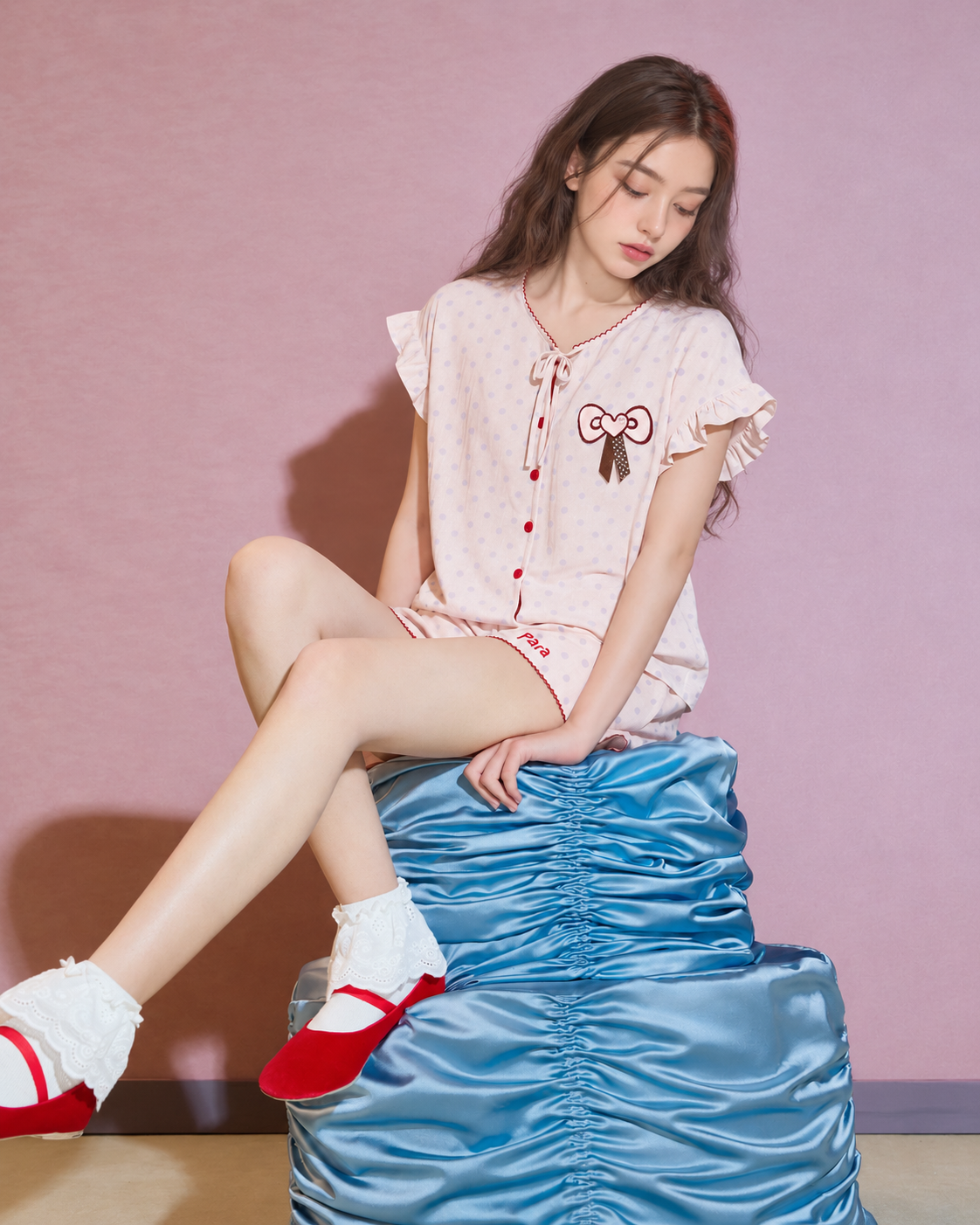 Side seated view of pearl pink polka-dot short pajama set - Roomden
