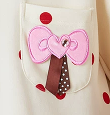 Polka Dot Cotton Blend Pajama Set – close-up of the pink bow, brown ribbon tails and chest pocket - Roomden