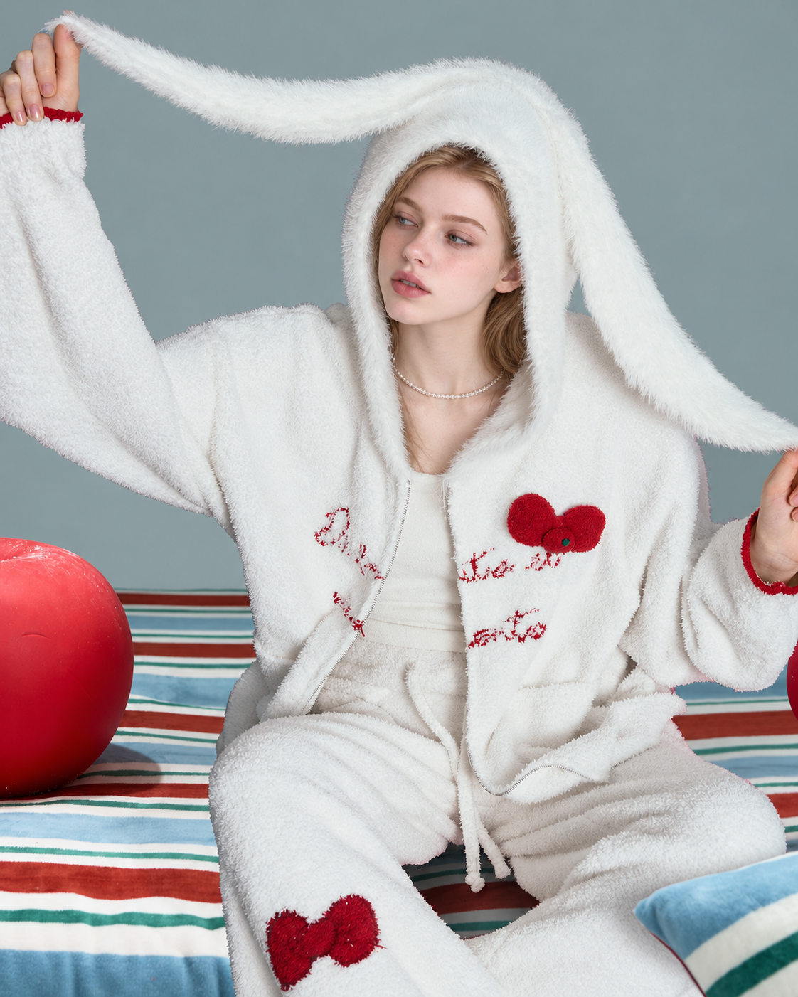 Red Bow Plush Pajama Set – ivory seated view with open zip and rabbit-ear hood - Roomden