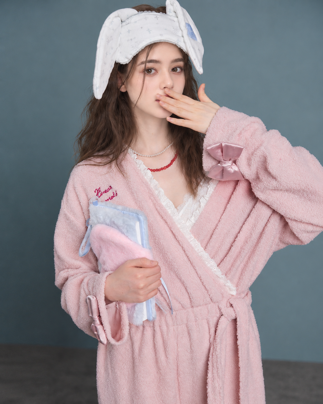 Blush Pink Plush Onesie – upper-body bow-cuff view - Roomden