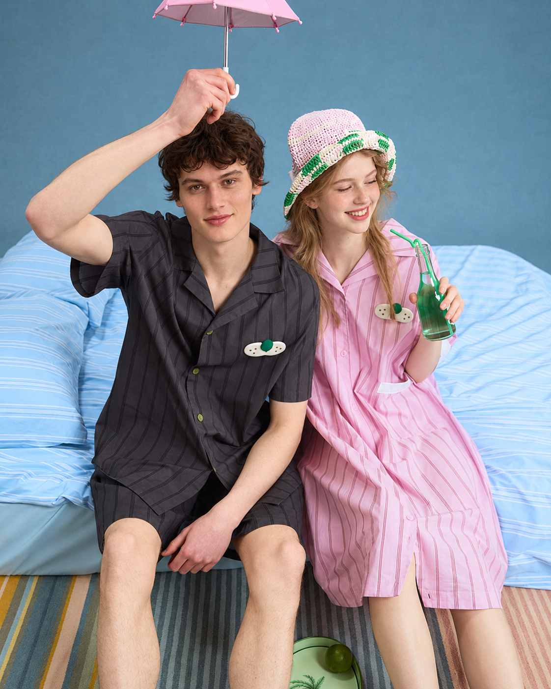 Men's Pinstripe Cotton Pajama Set – charcoal striped shirt and shorts, seated and raising an umbrella - Roomden