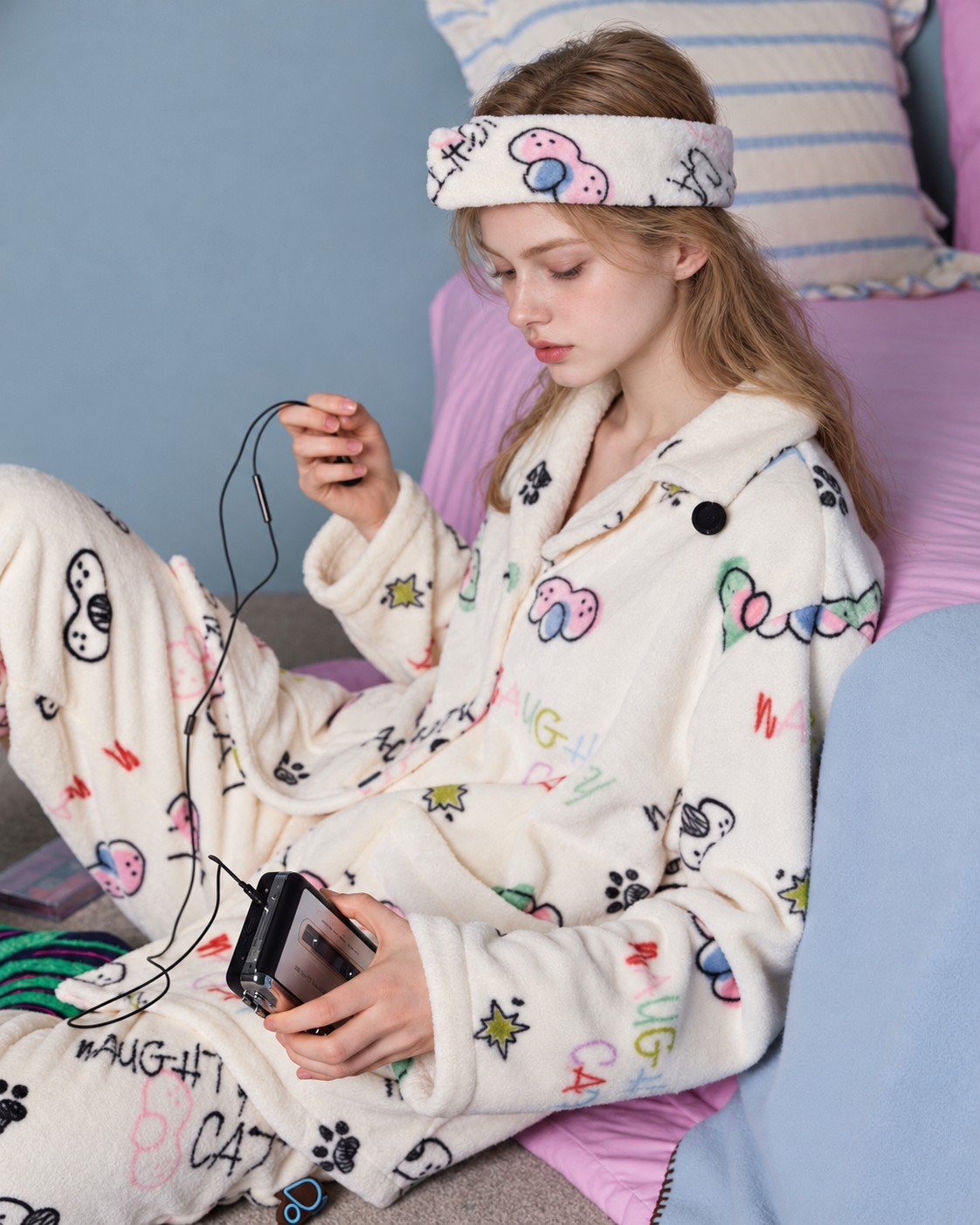 Doodlewhisk Cat Doodle Fleece Pajama Set – cream pajama set, seated with a cassette player - Roomden