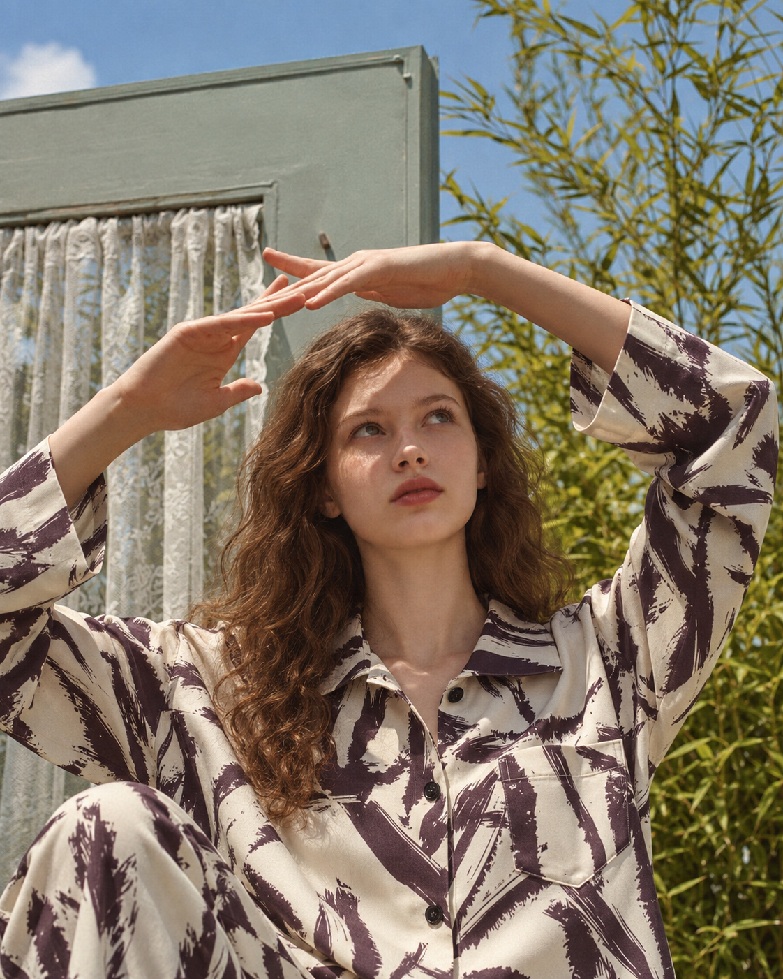 Brushstroke Palm Viscose-Rayon Pajama Set – hands raised in sunlight - Roomden