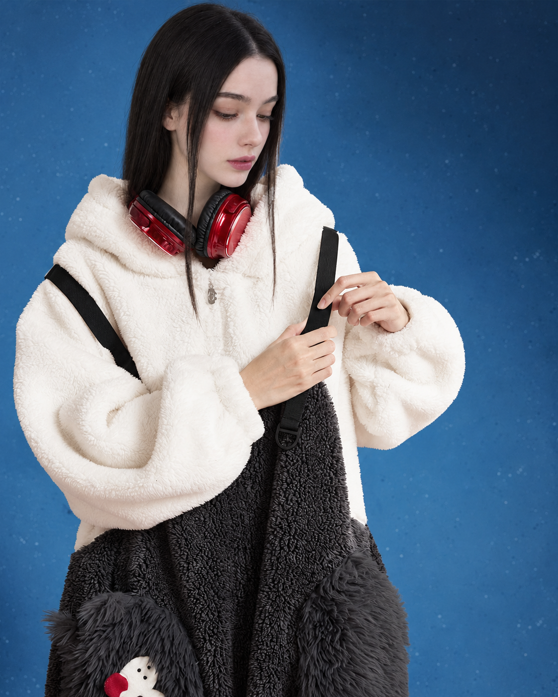 Close view of zipper, black straps and cat-face pockets on fleece one-piece pajamas
