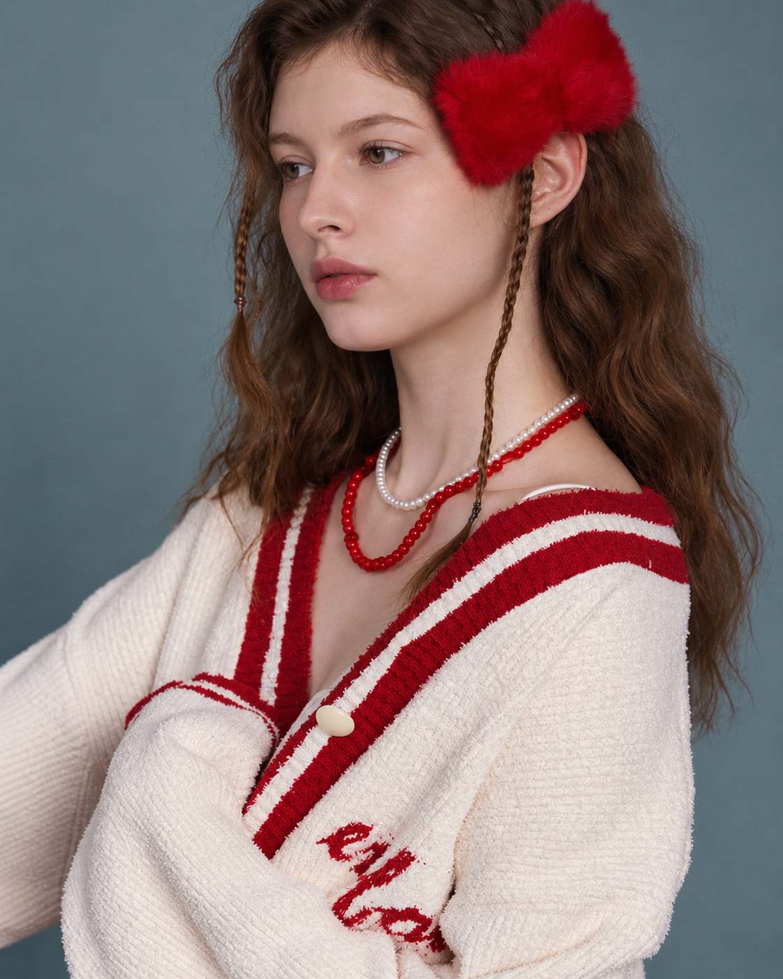 Side close view of neckline, button and knit texture
