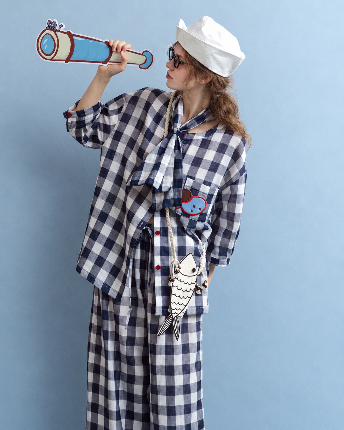 Cotton Double Gauze Pajama Set – navy checks, side view holding a telescope prop - Roomden