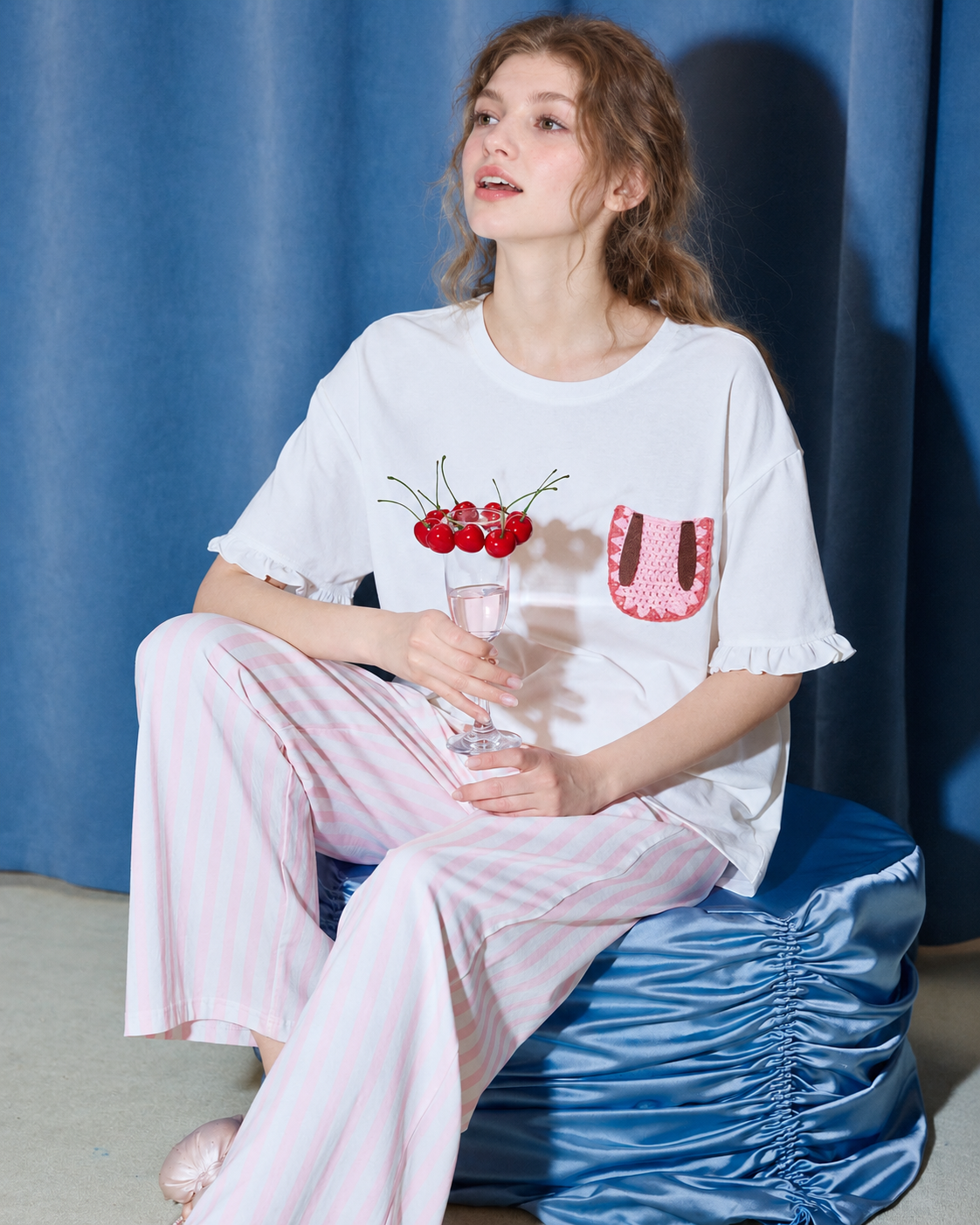 Seated lifestyle view with the rabbit-pocket pajama set