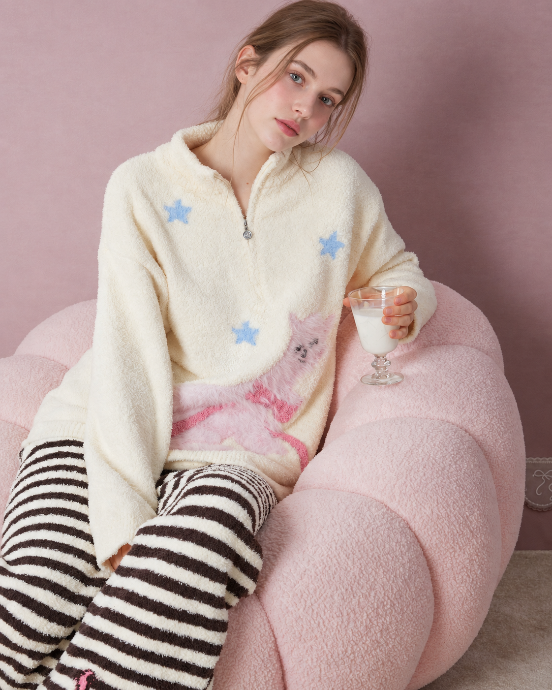 Half-zip cat and star pajama top shown seated with a cup - Roomden
