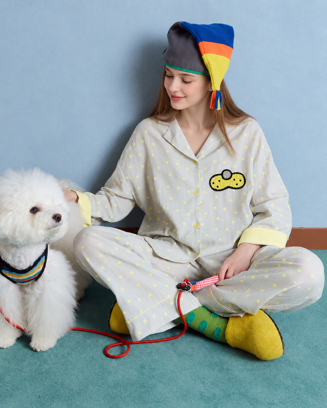 Women's gray and yellow dot cotton gauze pajama set – cross-legged view petting a dog - Roomden