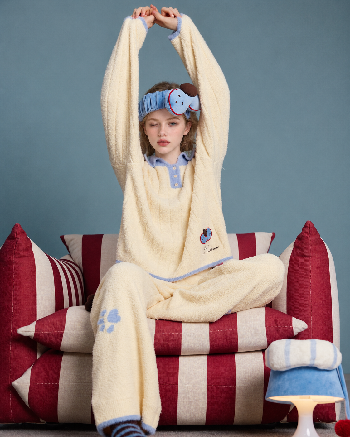 Plush Paw Print Pajama Set – cream yellow and blue seated overhead stretch - Roomden