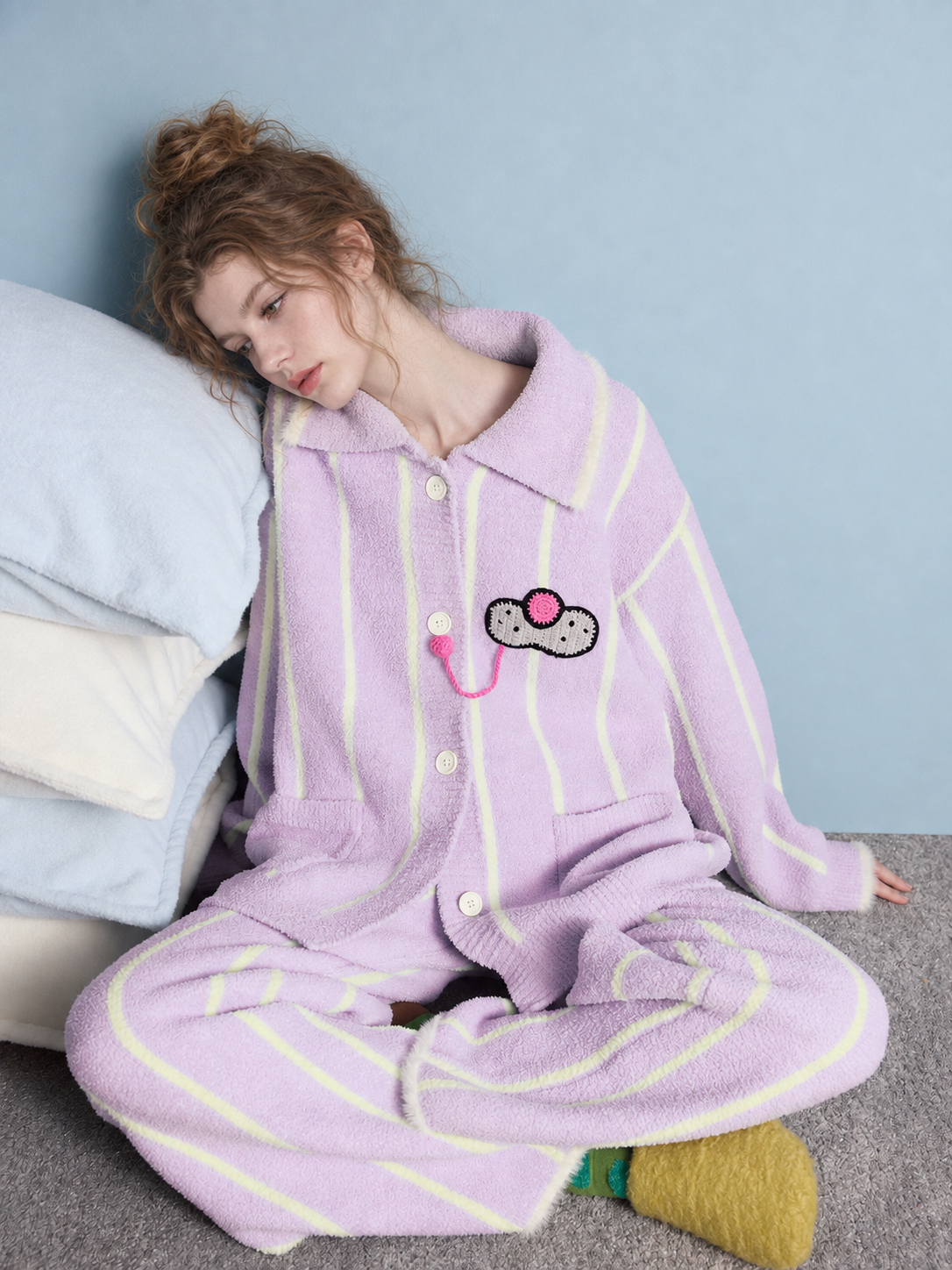 Striped Cat Motif Fleece Pajama Set – lavender, seated beside pillows - Roomden
