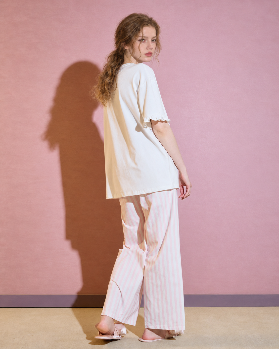 Rear view of the white top and pink striped trousers