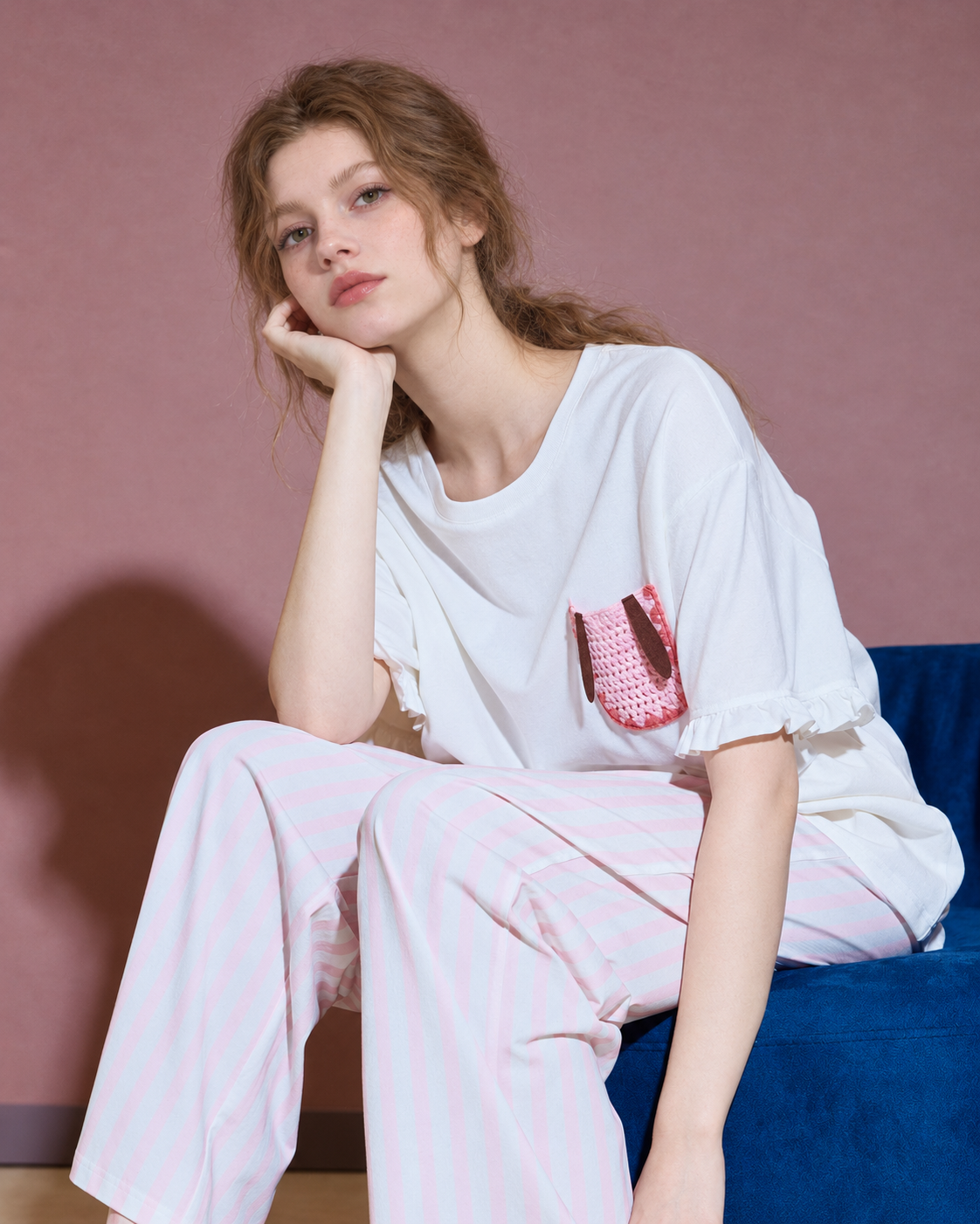 Seated view showing the round neckline and rabbit pocket