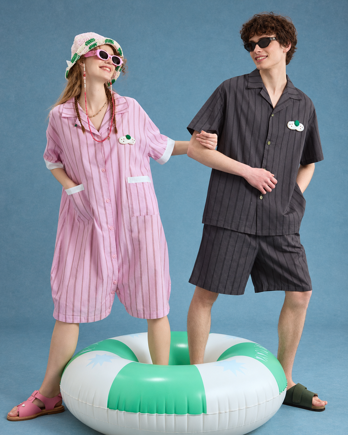 Men's Pinstripe Cotton Pajama Set – charcoal striped shirt and shorts, standing beside a green swim ring - Roomden