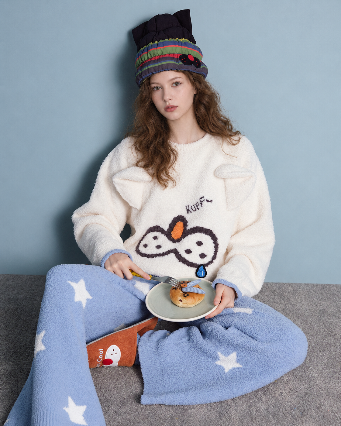 Cat & Star Plush Pajama Set – seated view of the plush top and star-pattern trousers - Roomden