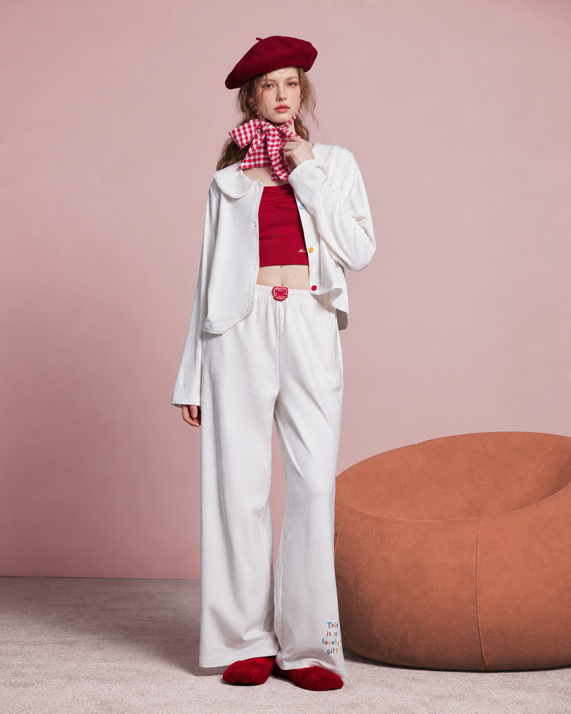 Front view of an ivory apple-detail pajama set with a Peter Pan collar and wide-leg trousers.