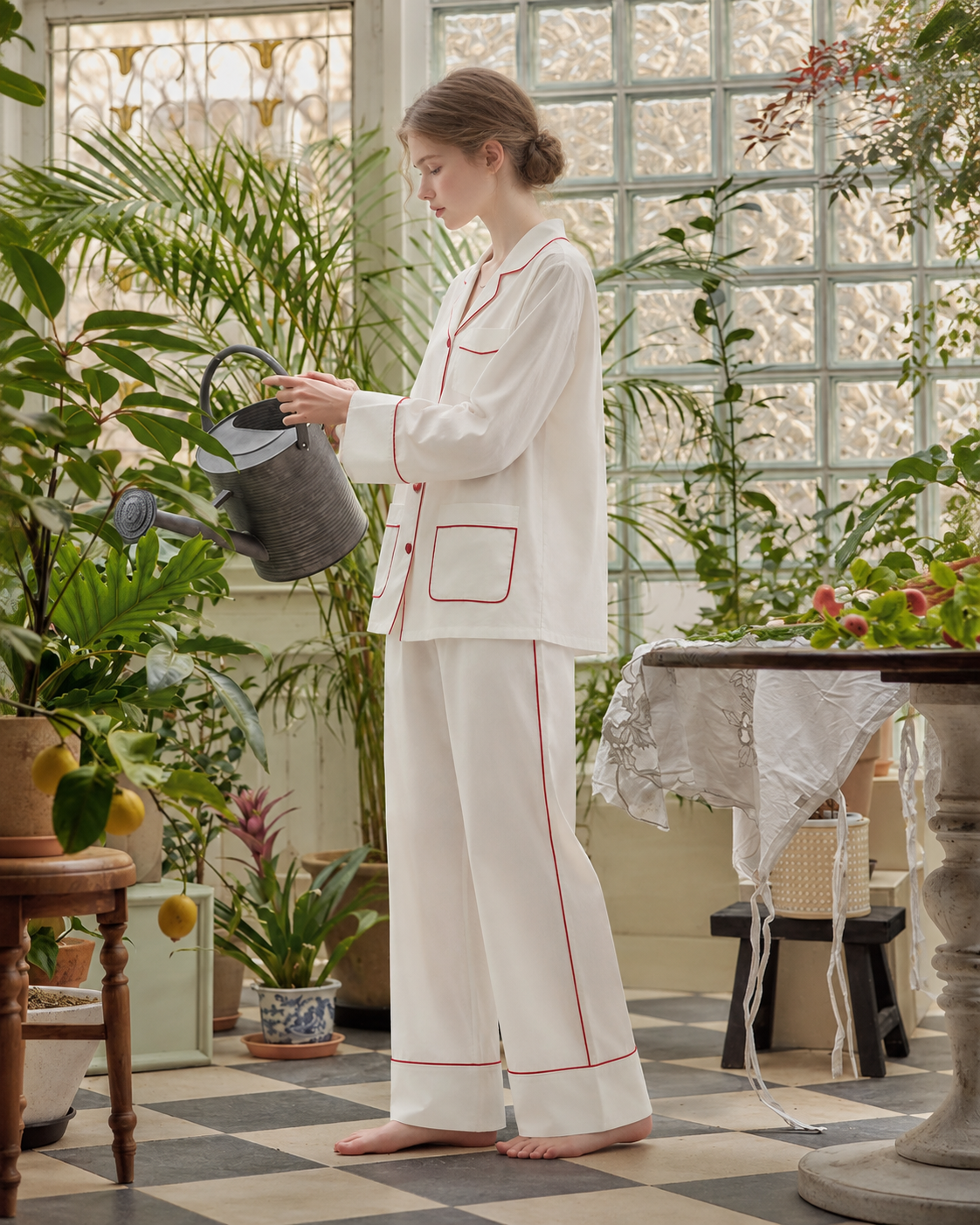 Linehaven contrast-piped pajama set in white, watering plants in a sunlit conservatory - Roomden