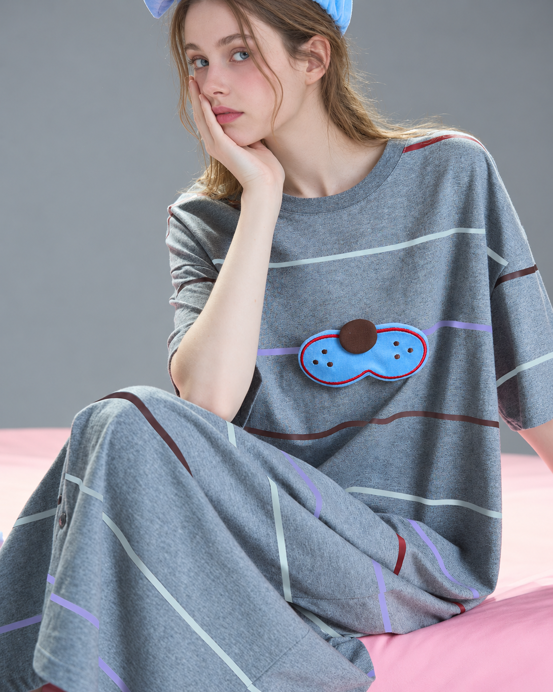 Cat striped one-piece pajamas – Seated cheek-on-hand view - Roomden