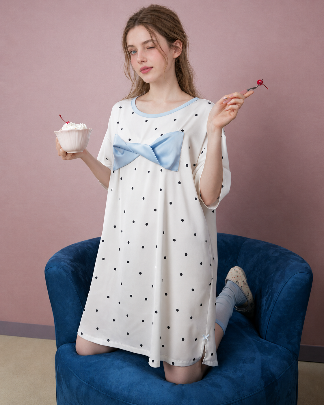 Blue Bow Polka Dot Nightgown – ivory nightgown kneeling on a blue chair - Roomden